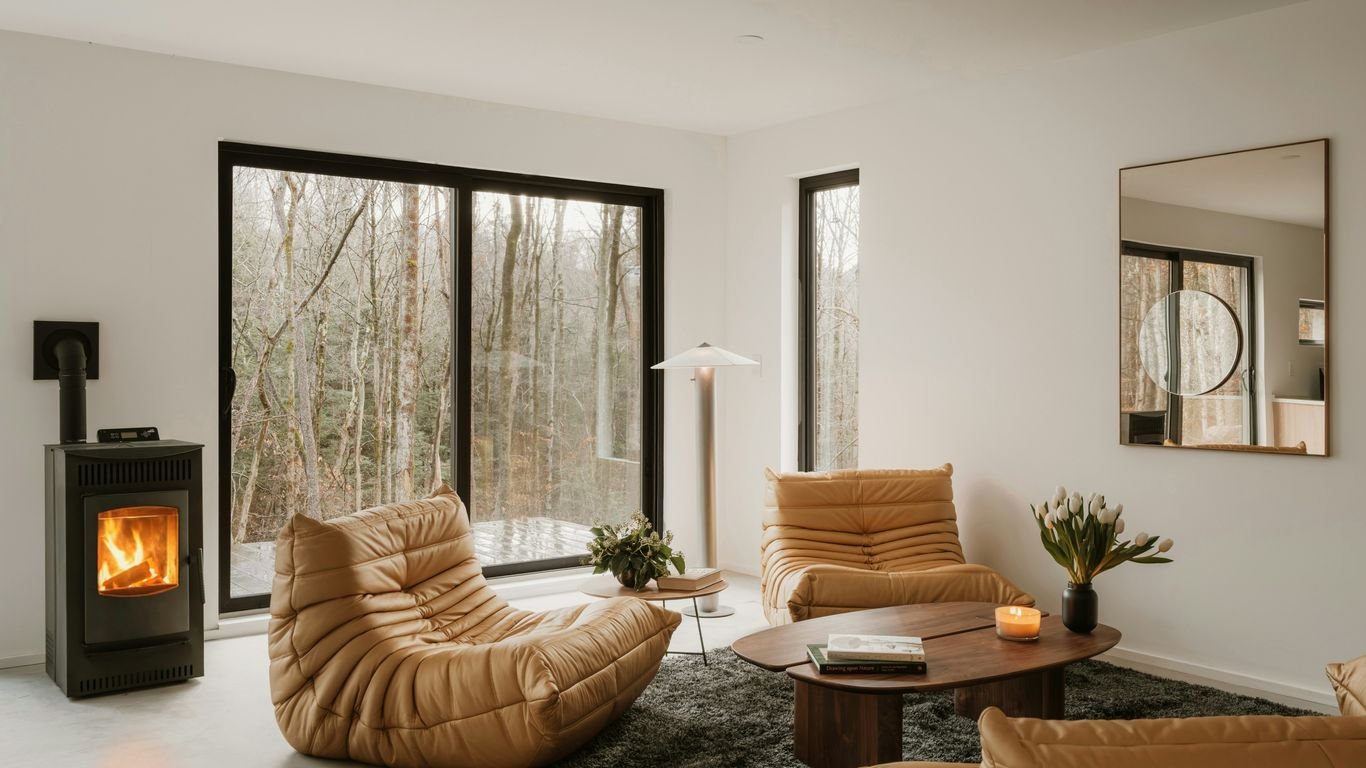 Modern living room with fireplace and forest view